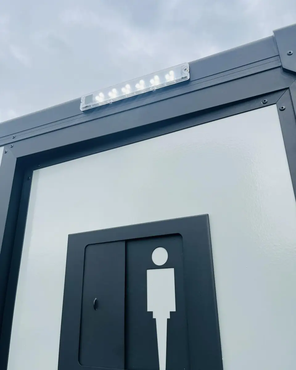 Men's door of a restroom trailer with a gender sign