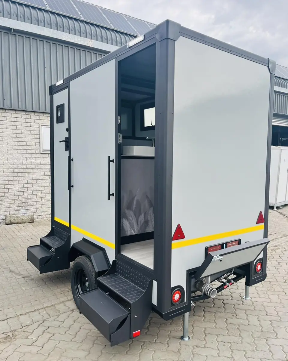 Restroom trailer seen from the rear with steps and lights